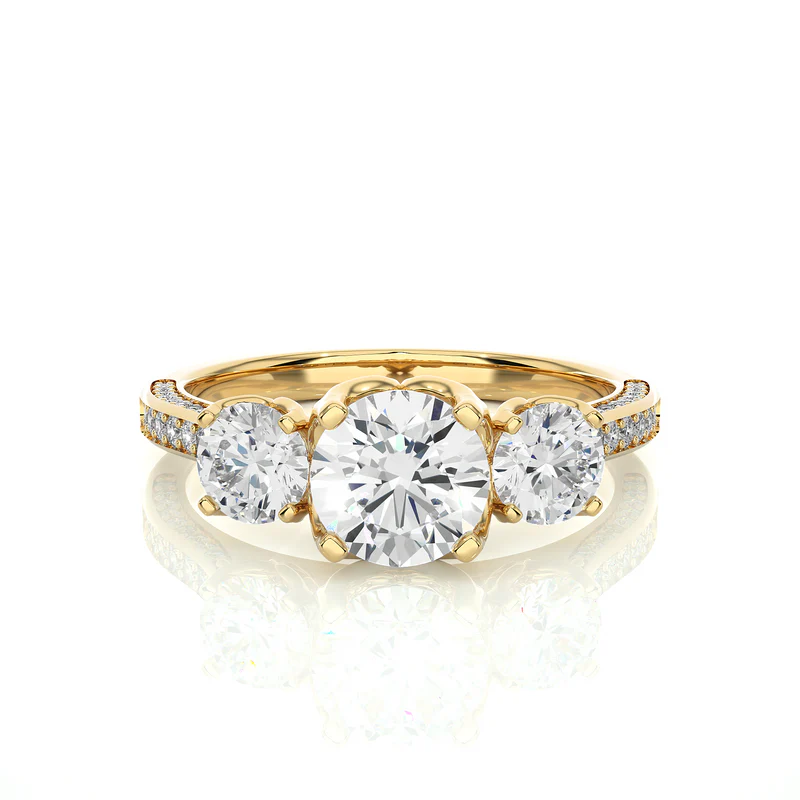 Front view of 2 carat round moissanite filigree three stone engagement ring in yellow gold, highlighting the brilliant center moissanite stone