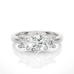 Load image into Gallery viewer, Front view of 2 Carat Round Moissanite Three Stone Engagement Ring In white gold, highlighting the brilliant center moissanite stone.