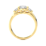 Load image into Gallery viewer, Side profile of 2 Carat Round Moissanite Three Stone Engagement Ring In Yellow Gold, highlighting the prong setting.