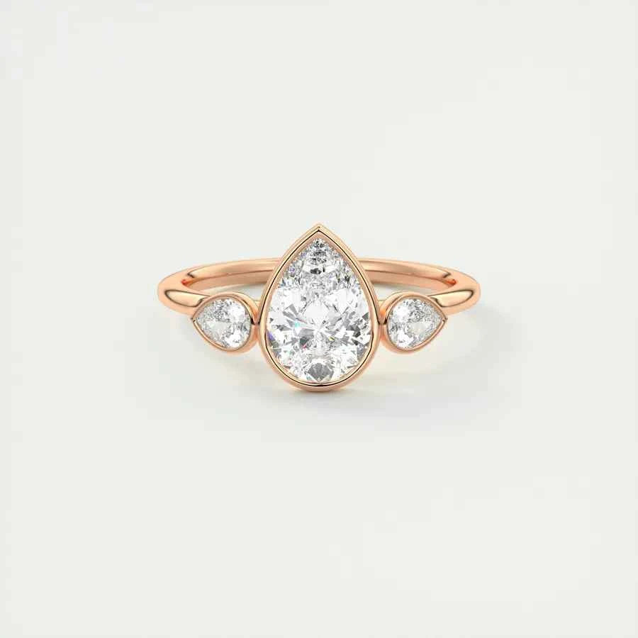 2 carat pear cut three stone bezel set moissanite ring in rose gold