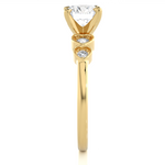 Load image into Gallery viewer, Side profile of Front view of 1.50 Ct Round cut Moissanite Five Stone Engagement Ring In Yellow Gold, highlighting the brilliant center moissanite stone., highlighting the prong setting.