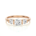 Load image into Gallery viewer, Front view of 2 Carat Round Cut Moissanite Three Stone Engagement Ring In Rose Gold, highlighting the brilliant center Moissanite stone.