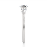 Load image into Gallery viewer, Side profile of 2 Carat Round Cut Moissanite Three Stone Engagement Ring In White Gold, highlighting the brilliant center moissanite stone., highlighting the prong setting.