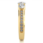 Load image into Gallery viewer, Side profile of 2 Ct Round Moissanite Three Stone Engagement Ring In Yellow Gold, highlighting the brilliant center moissanite stone, highlighting the prong setting.