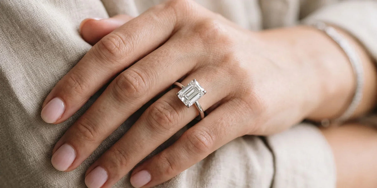 Emerald solitaire ring with an open gallery undercarriage