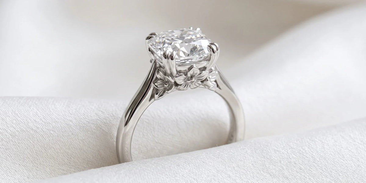 Cushion solitaire ring with intricate floral undercarriage sculpting