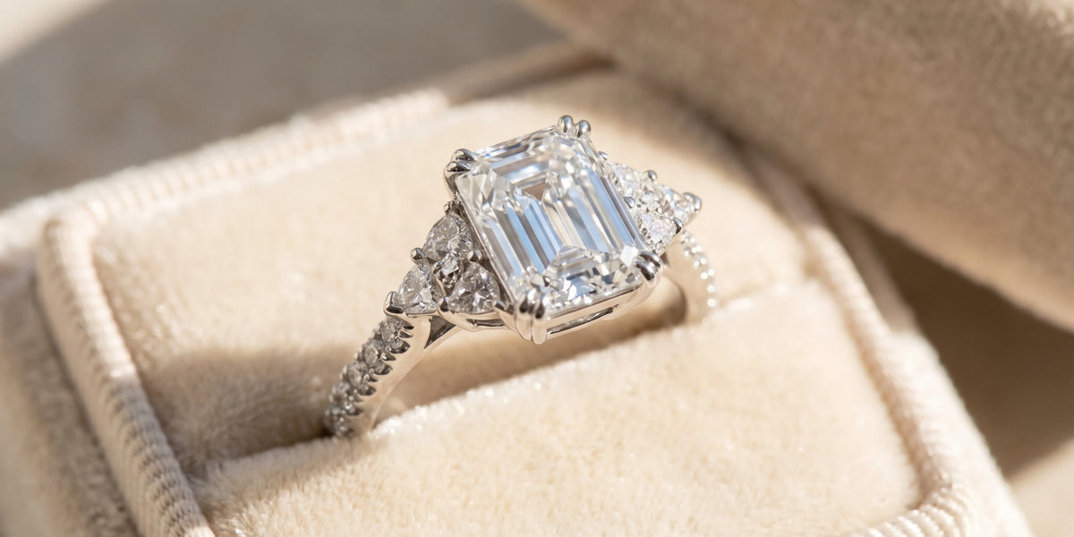 Emerald cut cathedral engagement ring with triangular side clusters: a perfect blend of elegance and brilliance