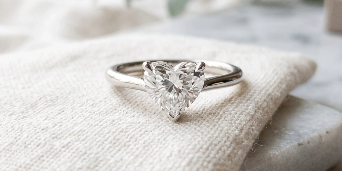 Heart shaped solitaire ring with sleek minimalist profile: modern romance in its purest form