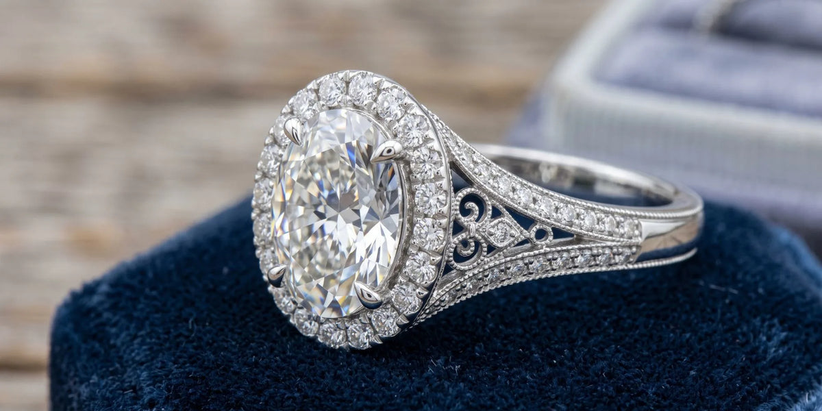 Oval halo accent ring with an intricate wire gallery
