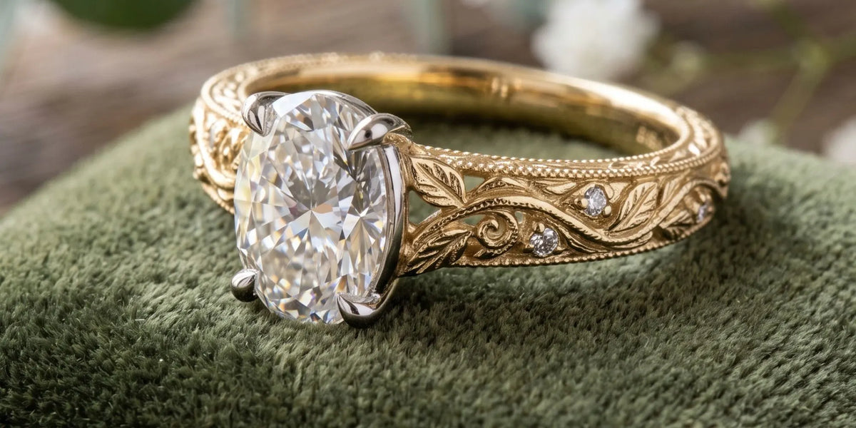 Oval solitaire ring with leaf textured accent detailing