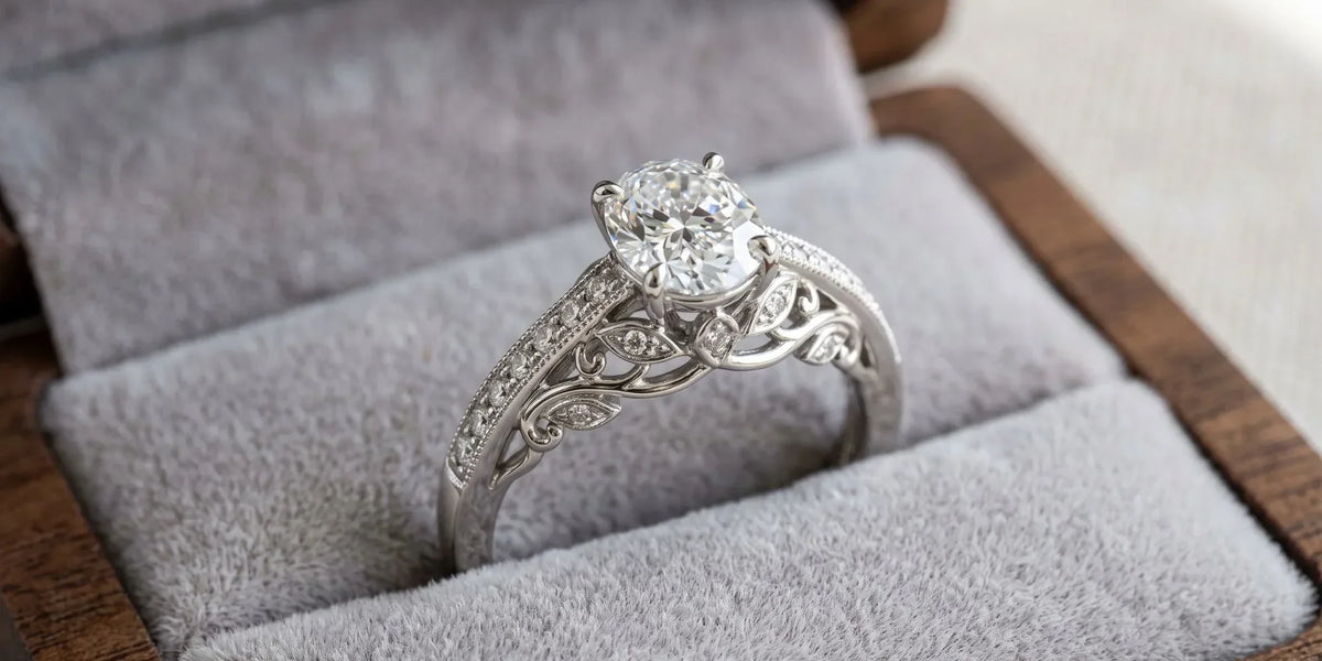 Oval solitaire accent ring with a leaf motif wire gallery