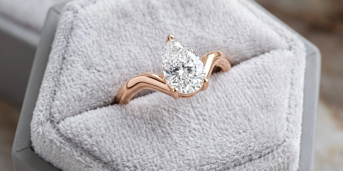 Pear solitaire ring with sculpted v shape contour: a modern expression of grace and elegance