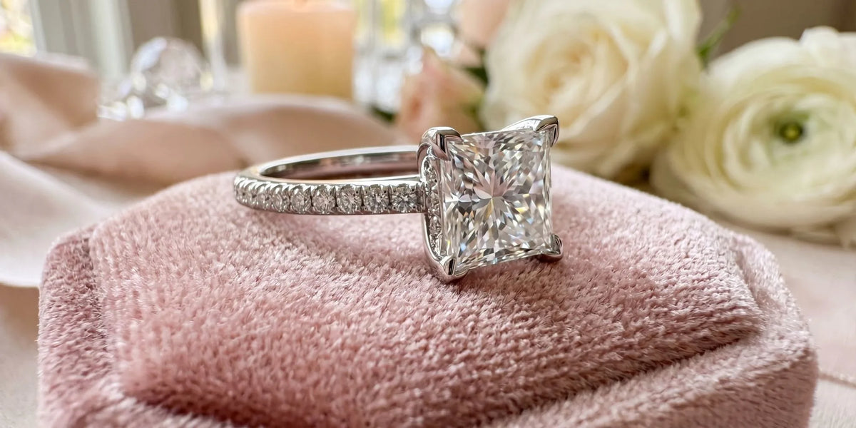Princess solitaire ring with hidden surprise accent stone
