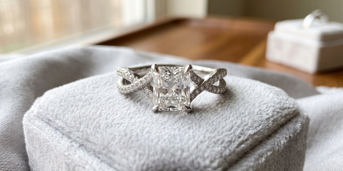 Radiant cut solitaire accent ring with intertwining pavé brilliance: a modern twist on timeless elegance