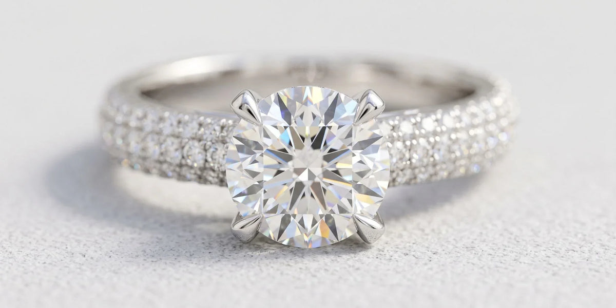 Round solitaire accent ring with a triple row moissanite band