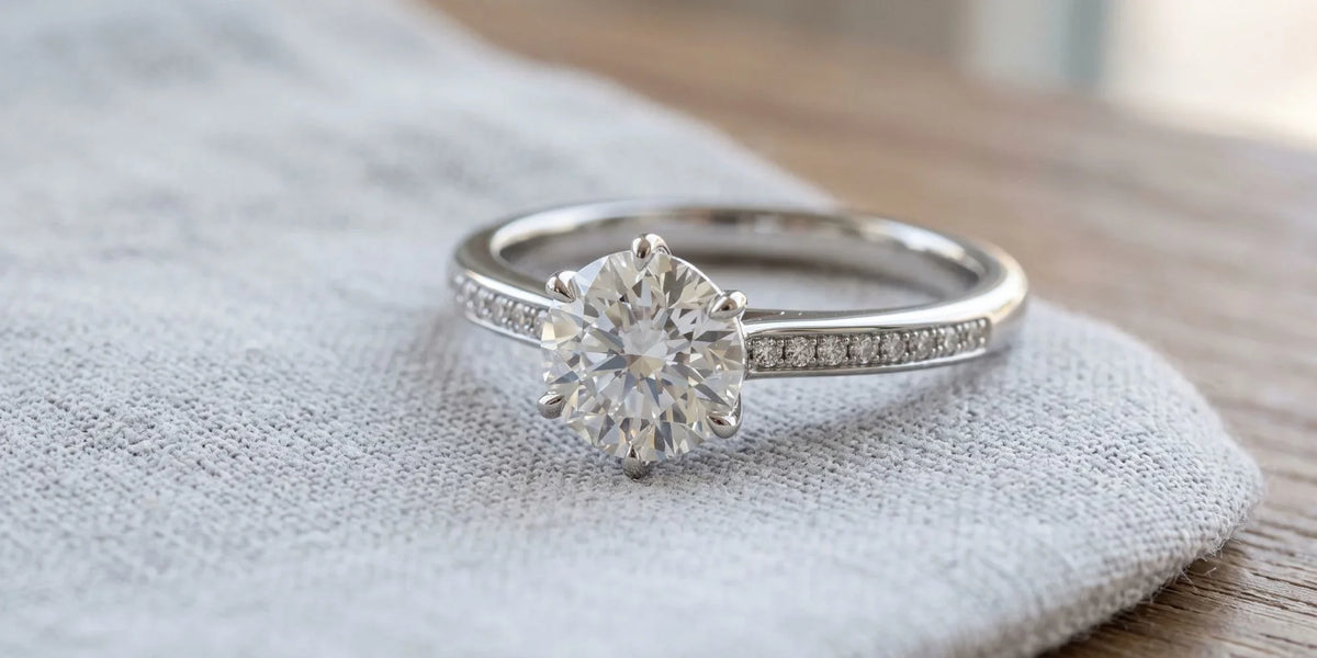 Round solitaire ring with minimalist inset brilliance