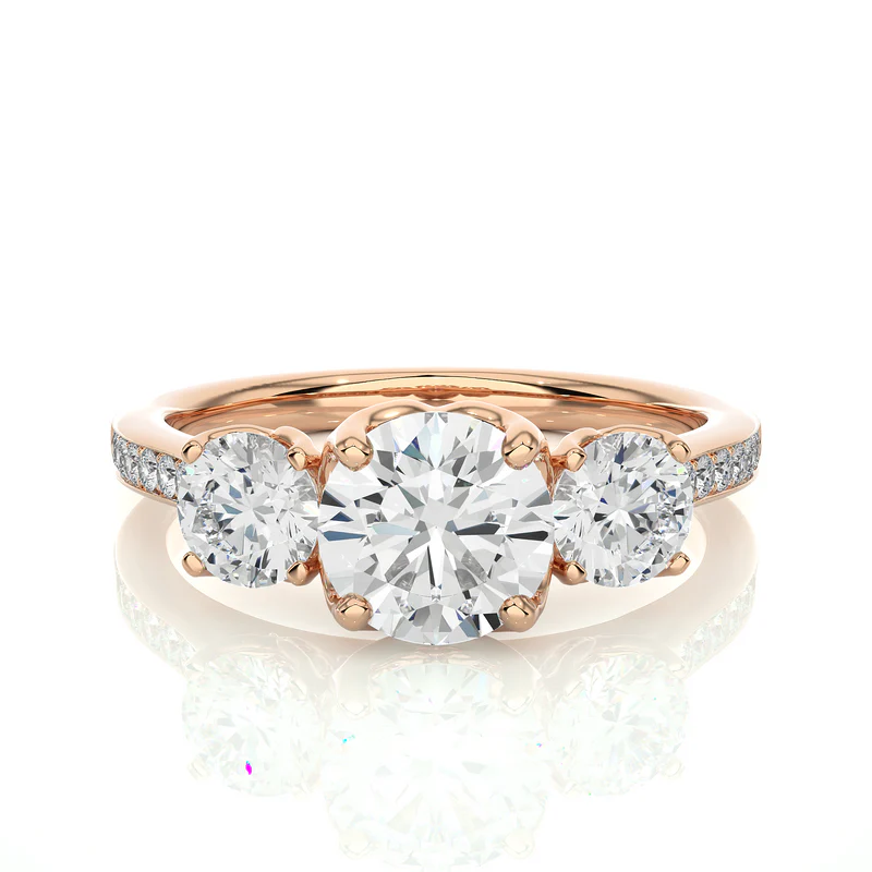 Front view of 2.50 Ct Round Moissanite Three Stone Engagement Ring In Rose Gold, highlighting the brilliant center moissanite stone.