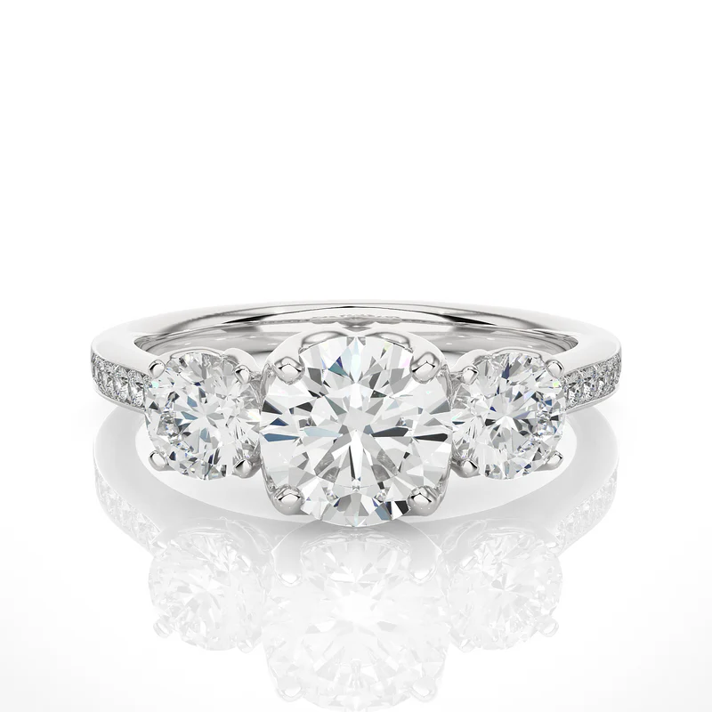 Front view of 2.50 Carat Round Moissanite Three Stone Engagement Ring In White Gold, highlighting the brilliant center moissanite stone.