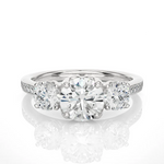 Load image into Gallery viewer, Front view of 2.50 Carat Round Moissanite Three Stone Engagement Ring In White Gold, highlighting the brilliant center moissanite stone.
