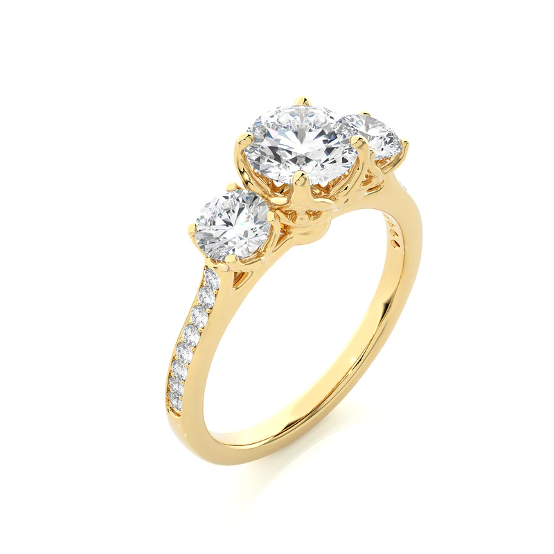 Angled view of 2.50 Carat Round Moissanite Three Stone Engagement Ring in Yellow Gold, showcasing the band and setting.​