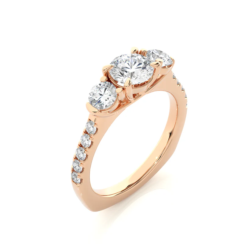 Angled view of 2 carat round moissanite engagement three stone ring in rose gold, showcasing the band and setting