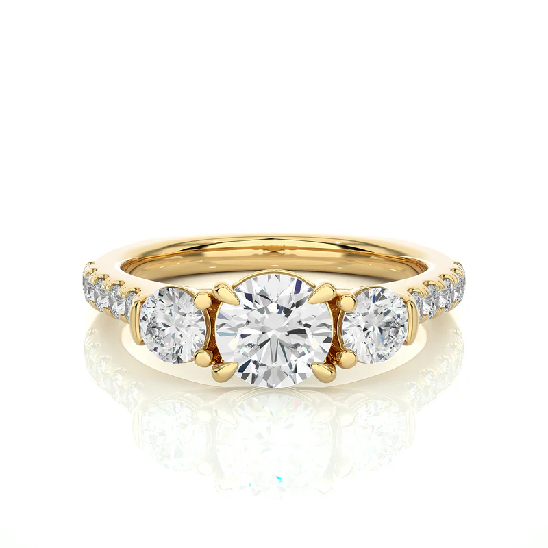 Front view of 2 carat round moissanite engagement three stone ring in yellow gold, highlighting the brilliant center moissanite stone