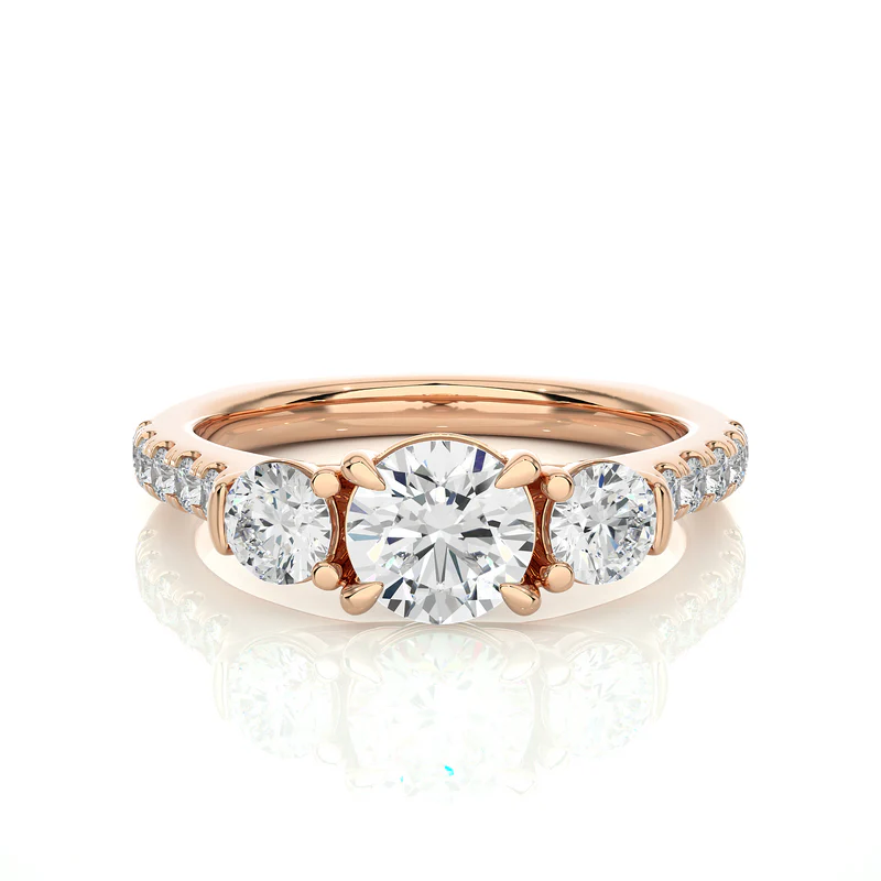 Front view of 2 Carat Round Moissanite Engagement Three Stone Ring In Rose Gold, highlighting the brilliant center moissanite stone.
