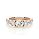 Load image into Gallery viewer, Front view of 2 Carat Round Moissanite Engagement Three Stone Ring In Rose Gold, highlighting the brilliant center moissanite stone.

