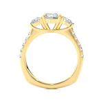Load image into Gallery viewer, Side profile of 2 Carat Round Moissanite Engagement Three Stone Ring In Yellow Gold, highlighting the prong setting.
