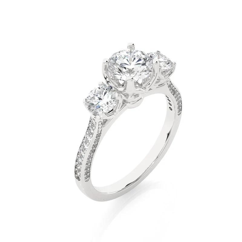 Angled view of 2 carat round moissanite filigree three stone engagement ring in white gold, showcasing the band and setting
