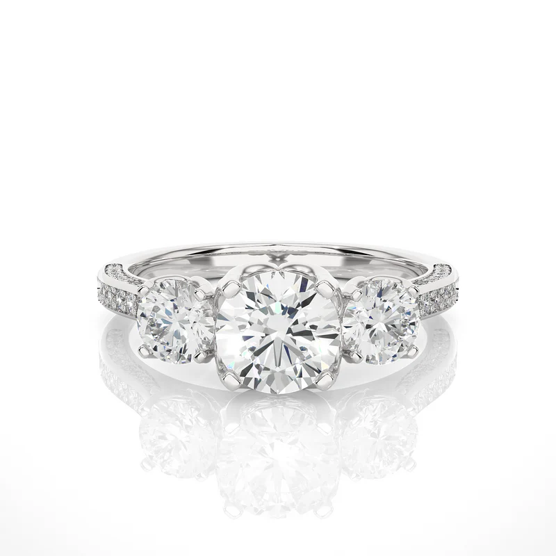 Front view of 2 carat round moissanite filigree three stone engagement ring in white gold, highlighting the brilliant center moissanite stone