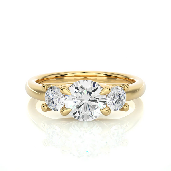 Front view of 2 Carat Round Moissanite Three Stone Engagement Ring In Yellow Gold, highlighting the brilliant center moissanite stone.