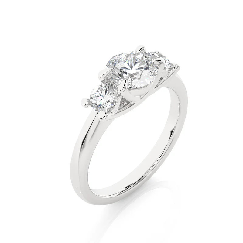 Angled view of 2 Carat Round Moissanite Three Stone Engagement Ring In White Gold, showcasing the band and setting.​