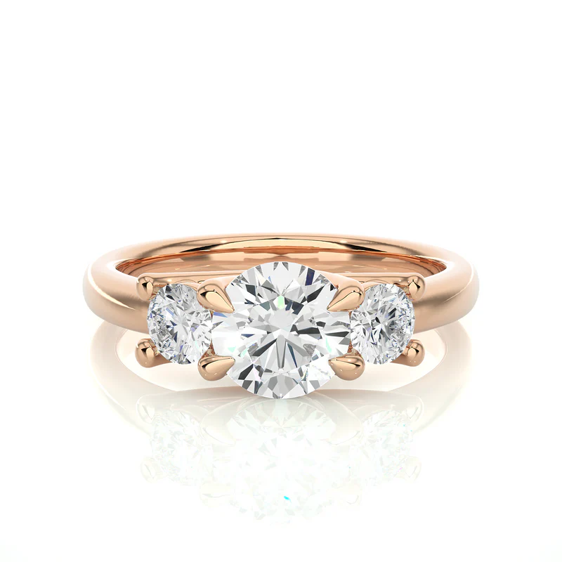 Front view of 2 carat round moissanite three stone engagement ring in rose gold, highlighting the brilliant center moissanite stone