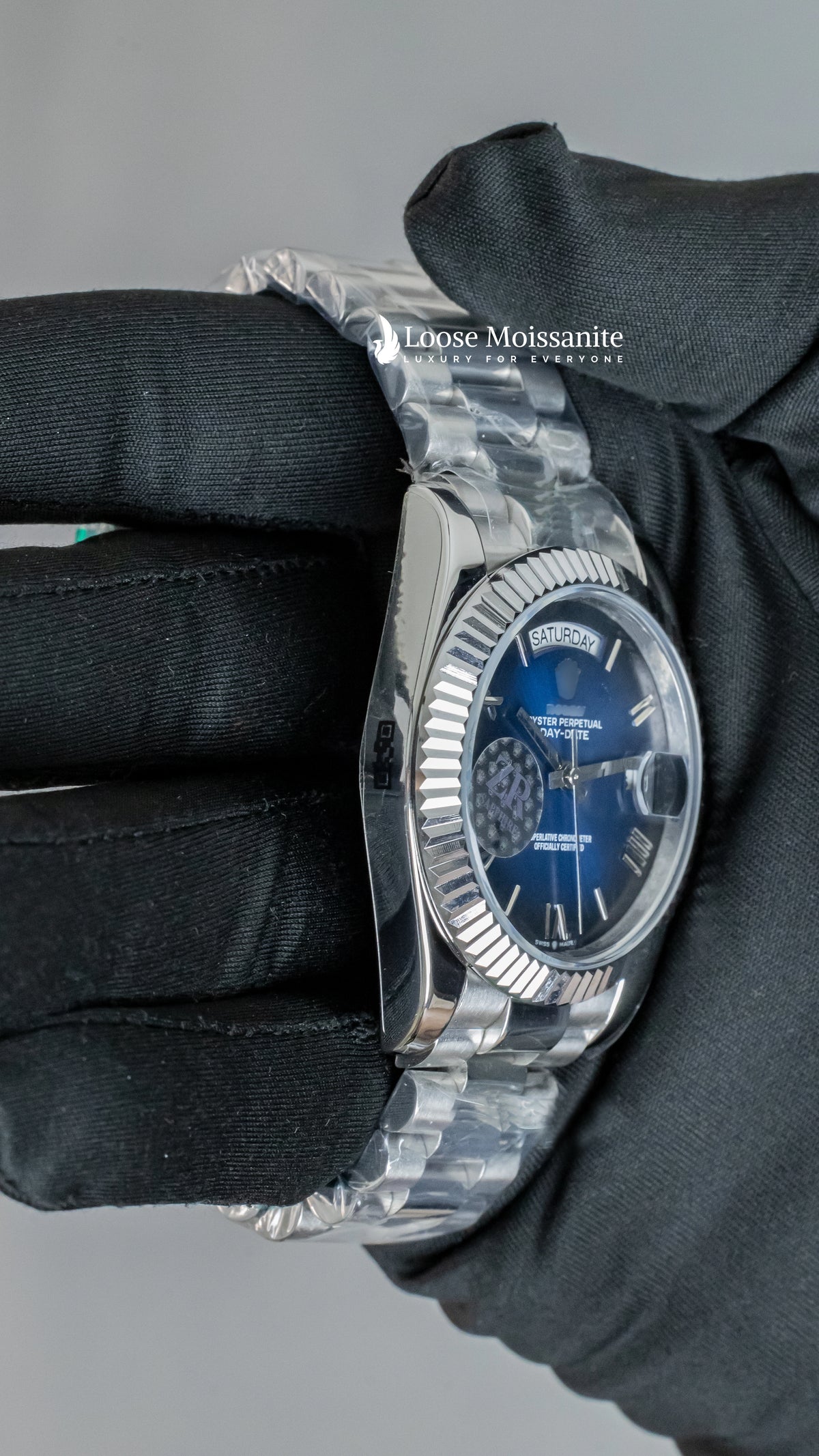 Side angle view of day date blue dial stainless steel plain watch