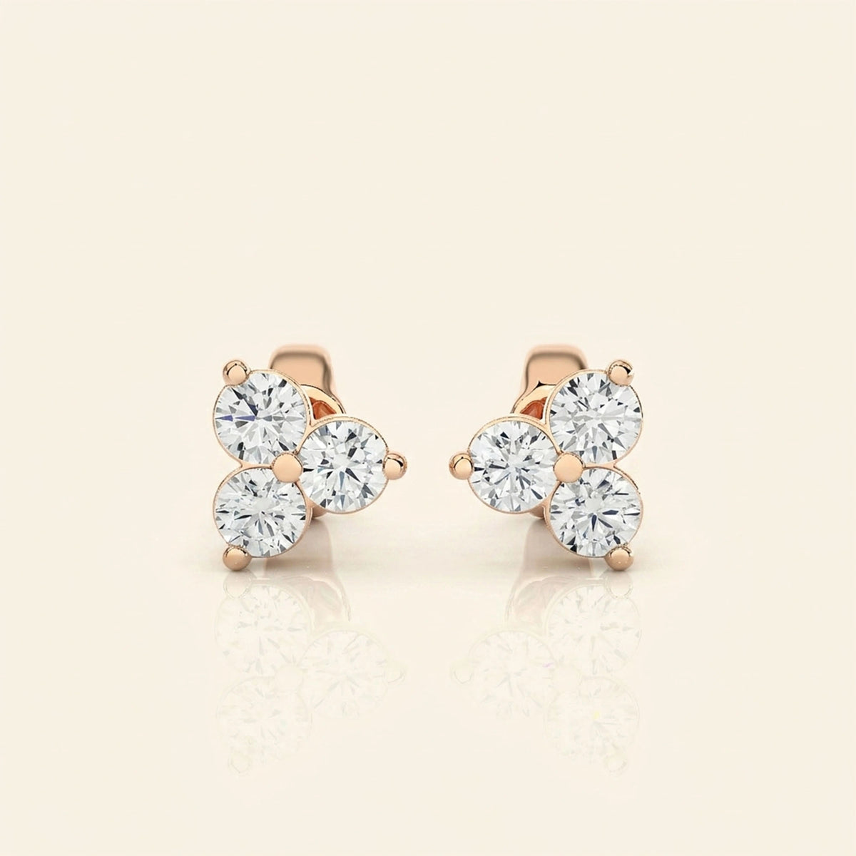 Front view of three stone stud earrings