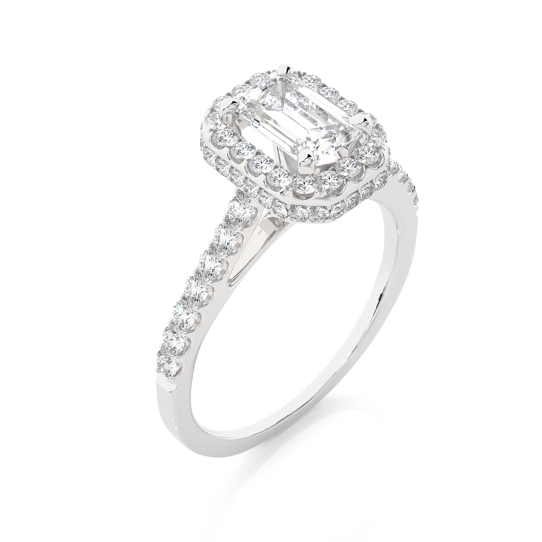 Angled view of 1.50 Ct Emerald Cut Moissanite Halo Engagement Ring In White Gold, showcasing the band and setting.​