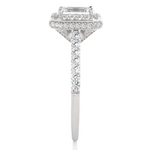 Load image into Gallery viewer, Side profile of 1.50 Ct Emerald Cut Moissanite Halo Engagement Ring In White Gold, highlighting the prong setting.
