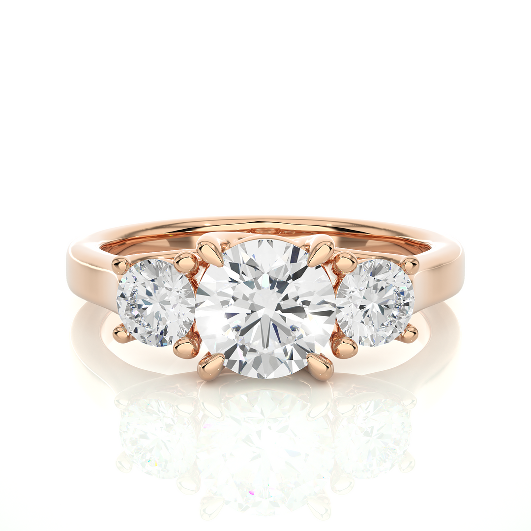 Front view of 1.50 Ct Round Moissanite Three Stone Engagement Ring In Rose Gold, highlighting the brilliant center Moissanite stone.