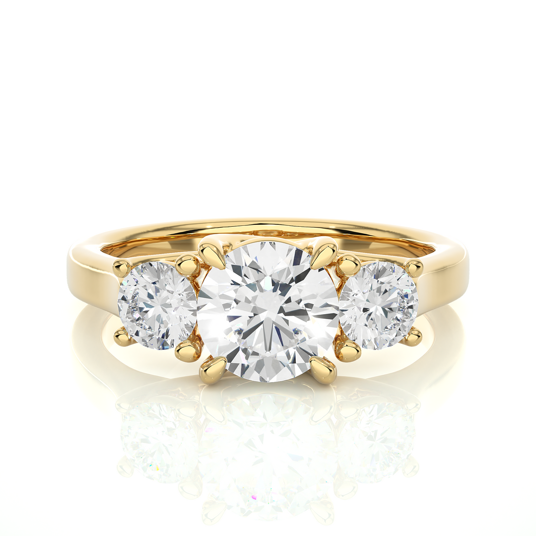 Front view of 1.50 Ct Round Moissanite Three Stone Engagement Ring In Yellow Gold, highlighting the brilliant center Moissanite stone.