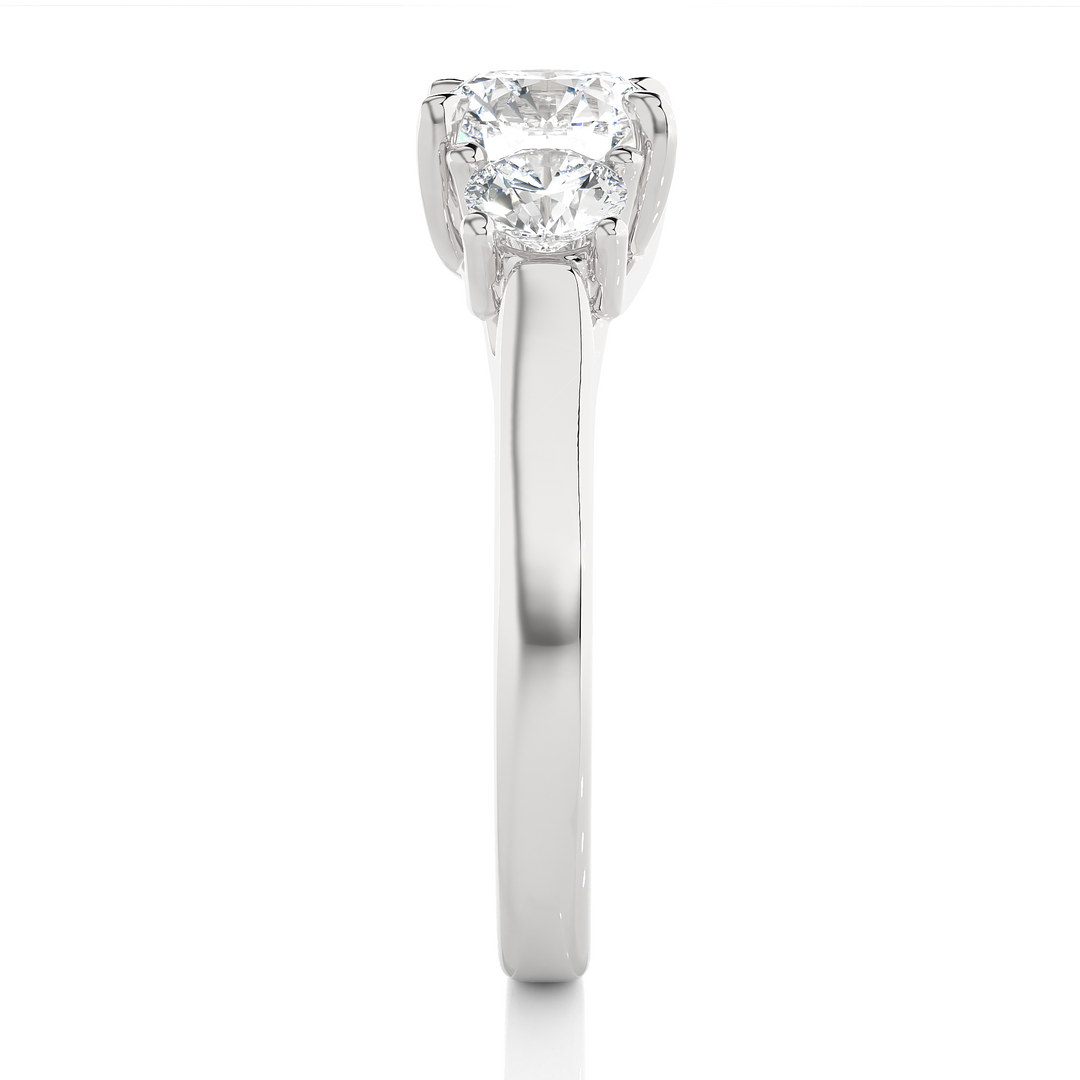 Side profile of 1.50 Ct Round Moissanite Three Stone Engagement Ring in White Gold, highlighting the brilliant center moissanite stone., highlighting the prong setting.