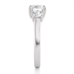 Load image into Gallery viewer, Side profile of 1.50 Ct Round Moissanite Three Stone Engagement Ring in White Gold, highlighting the brilliant center moissanite stone., highlighting the prong setting.

