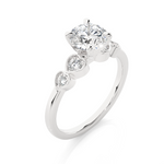 Load image into Gallery viewer, Angled view of 1.50 Ct Round cut Moissanite Five Stone Engagement Ring In White Gold, showcasing the band and setting.​
