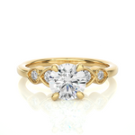 Load image into Gallery viewer, Front view of 1.50 Ct Round cut Moissanite Five Stone Engagement Ring In Yellow Gold, highlighting the brilliant center Moissanite stone.
