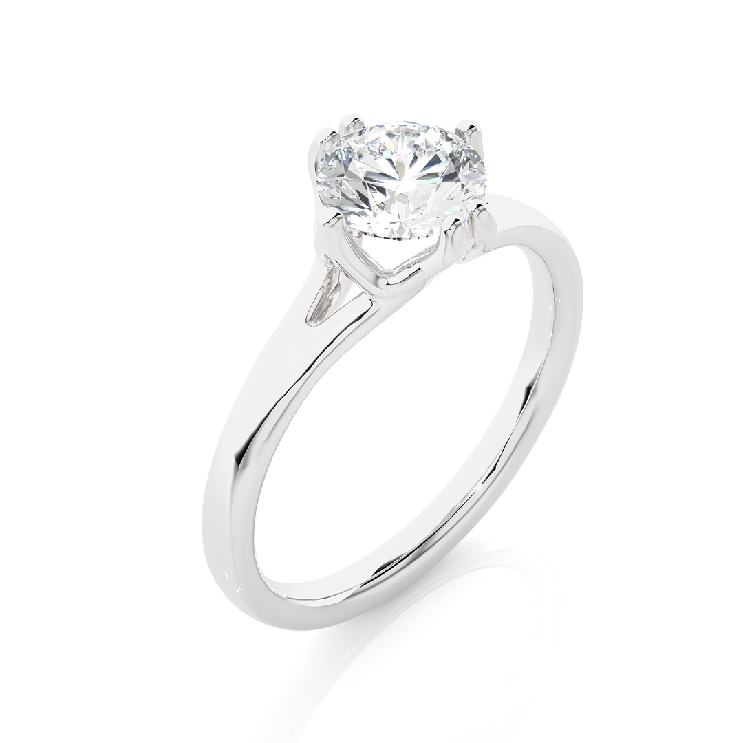 Angled view of 1 Ct Round Moissanite Solitaire Engagement Ring In White Gold, showcasing the band and setting.​