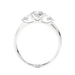 Load image into Gallery viewer, Side profile of 2 Carat Round Cut Moissanite Three Stone Engagement Ring In White Gold, highlighting the brilliant center moissanite stone., highlighting the prong setting.
