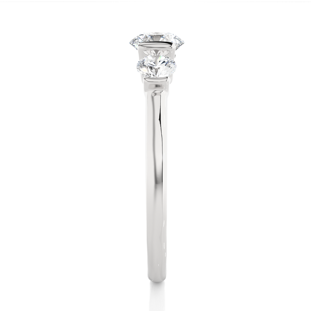 Side profile of 2 Carat Round Cut Moissanite Three Stone Engagement Ring In White Gold, highlighting the brilliant center moissanite stone., highlighting the prong setting.