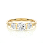 Load image into Gallery viewer, Front view of 2 Carat Round Cut Moissanite Three Stone Engagement Ring In Yellow Gold, highlighting the brilliant center Moissanite stone.
