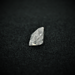 Load image into Gallery viewer, Side view of the emerald cut moissanite—sharp lines, elegant shape, and a brilliant shine from every angle.
