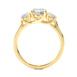 Load image into Gallery viewer, Side profile of 1.50 Ct Round Moissanite Three Stone Engagement Ring In Yellow Gold, highlighting the brilliant center moissanite stone., highlighting the prong setting.
